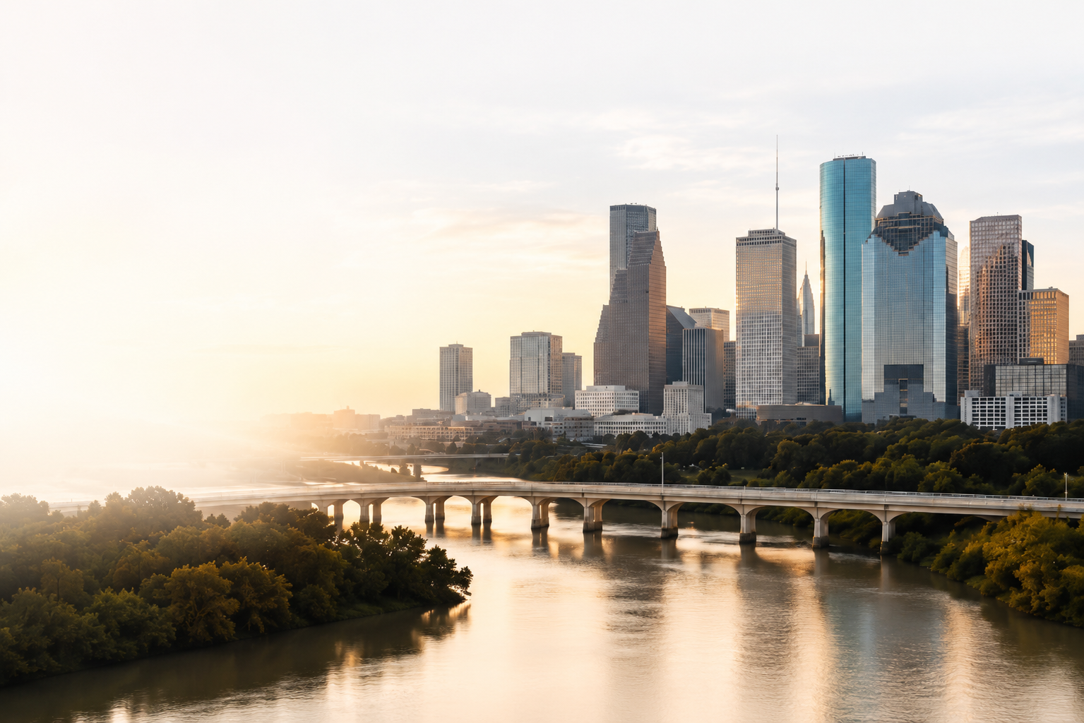 Houston skyline at sunrise over a bridge